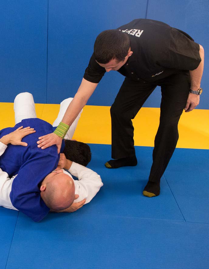 Referee signal for penalty on the ground - clenched fist raised