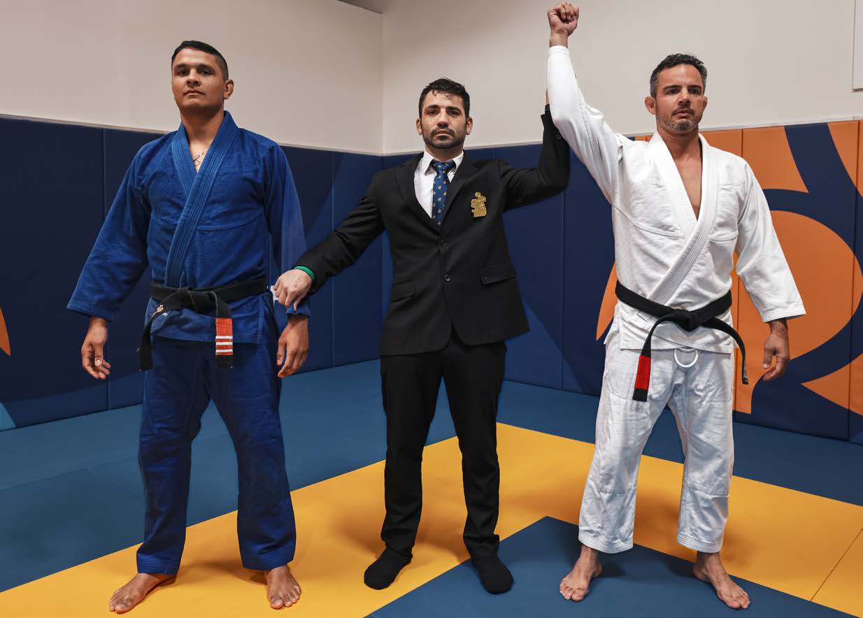 Referee signal to re-adjust gi - arms crossed downwards at waist height