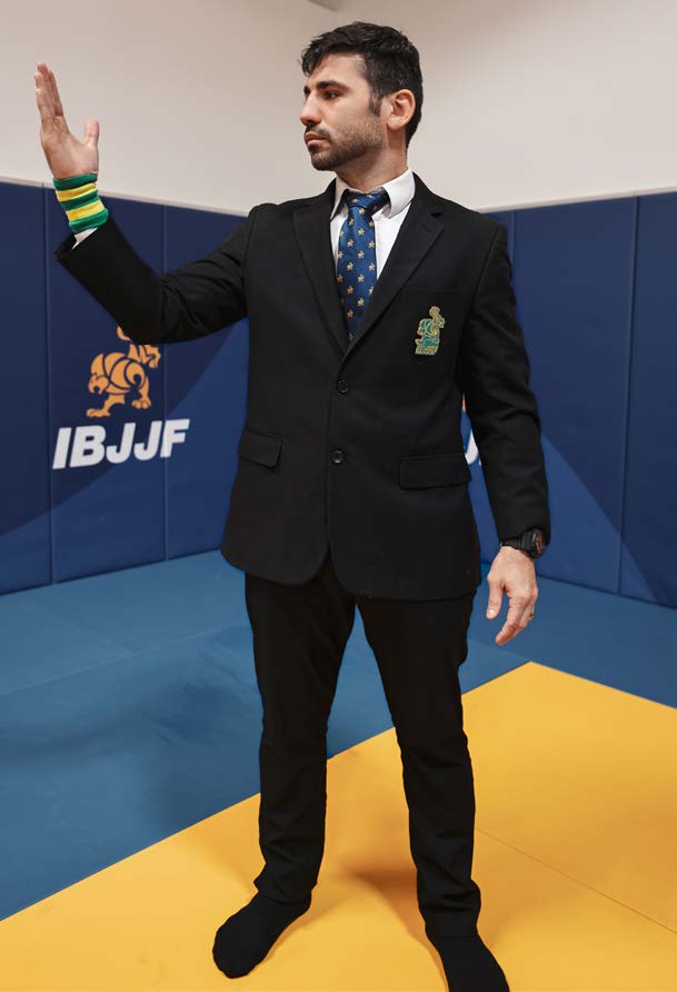 Referee signal to return to ground - arm extended to shoulder height