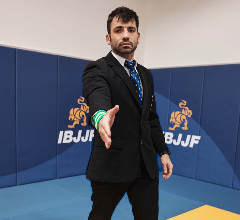 Referee signal to start the match - arm extended forward then lowered toward the ground